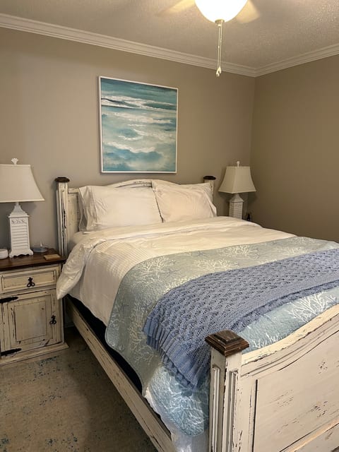 Queen bed in bedroom.