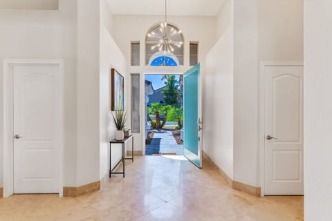 Welcome home! The signature oversized, turquoise door leads you into a wide angle view of your backyard oasis.