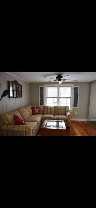 Cozy living room with sectional and recliner.