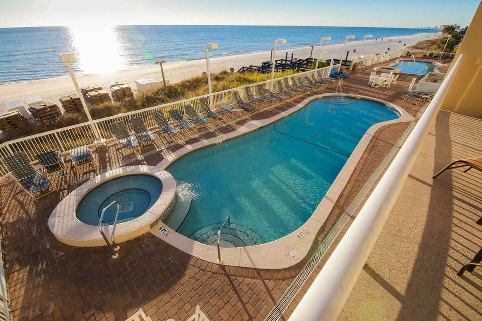 Yes, this can be YOUR vacation view!  Sundeck and Two Pools with hot tubs, one on each side of the building.