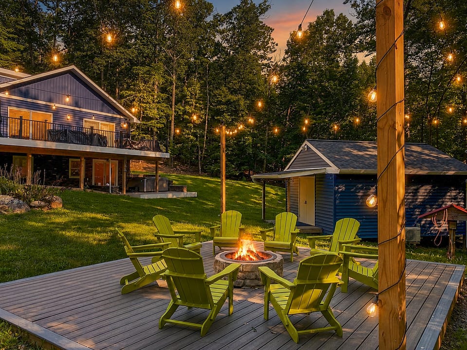 Cozy fire pit deck with string lights in a peaceful wooded setting