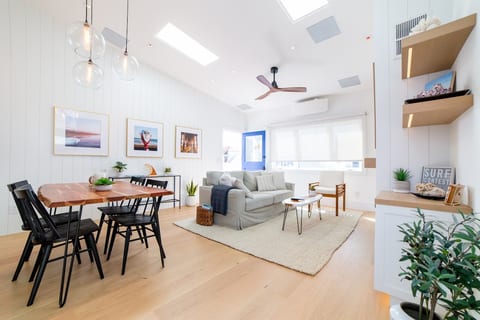Spacious and bright living room with high ceilings and skylights.