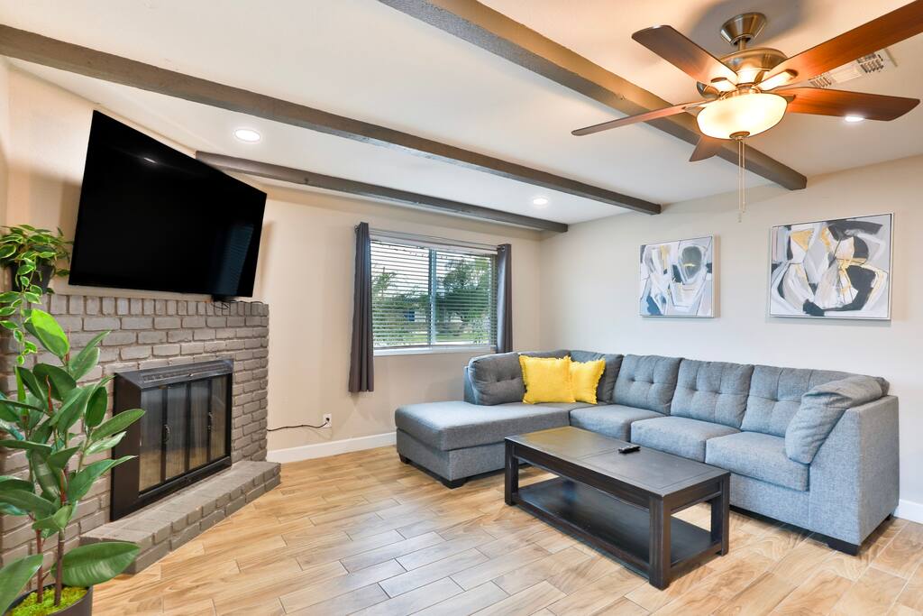 65 inch TV with couch in the living room