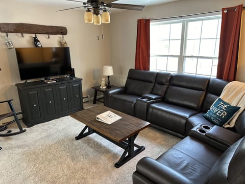 Main floor living room. 2 reclining chairs on the ends of the couch.