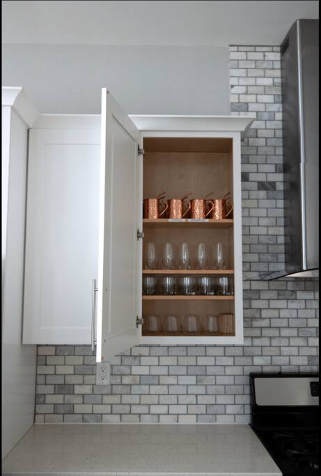 Kitchen | Glassware Cabinet | Stylish & Stocked
Open cabinet with neatly arranged glassware, including copper mugs, tumblers, and wine glasses—ready for coffee, cocktails, or a celebratory toast.