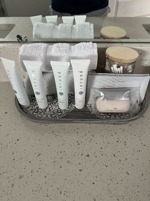 Each bathroom comes stocked with individually wrapped amenities (shampoo, conditioner, lotion, and bar soap) plus makeup removers, Q-tips, and wash cloths