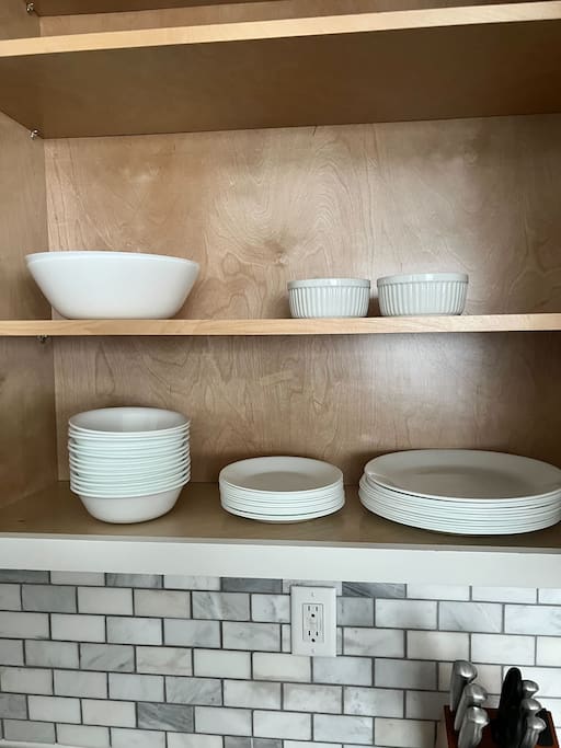 Kitchen | Open Cabinet | Dishware Essentials
Open kitchen cabinet stocked with clean white bowls, plates, and ramekins—everything you need for a fully equipped, home-cooked meal experience.