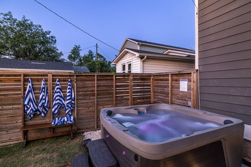 Backyard | Hot Tub Area | Private Retreat
Unwind in our private fenced backyard featuring a 7-person hot tub with LED lighting, towel hooks with striped robes, and a peaceful setting perfect for evening relaxation.