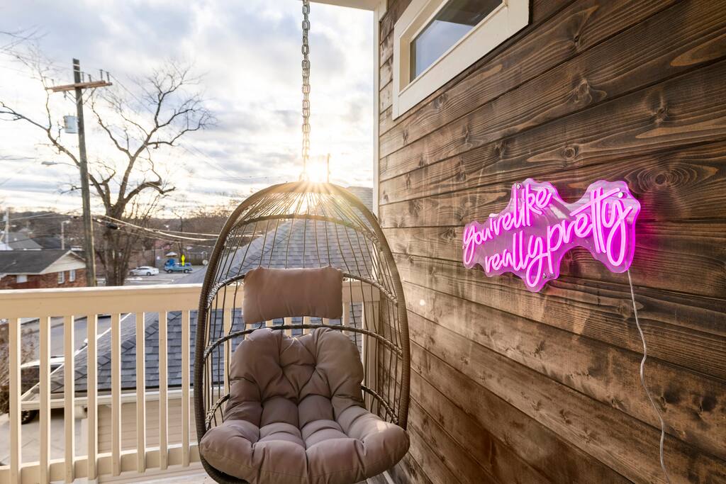 "You're like really pretty" neon sign on the upstairs balcony complete with a hanging egg chair makes for some great photos!