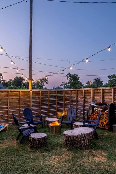 Relax under the stars with a Smokeless Firepit, Private Backyard, Unlimited Firewood, Bistro lights, Corn Hole, and Natural stump seating.
