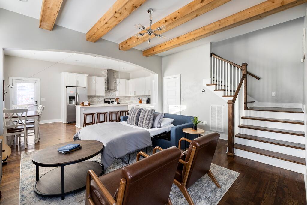 Living Room | Kitchen | Open Concept | 1st Floor
Spacious open-concept living area with exposed beams, leather chairs, pull-out sofa bed, and a view into the modern kitchen—perfect for relaxing and entertaining during your Nashville getaway.