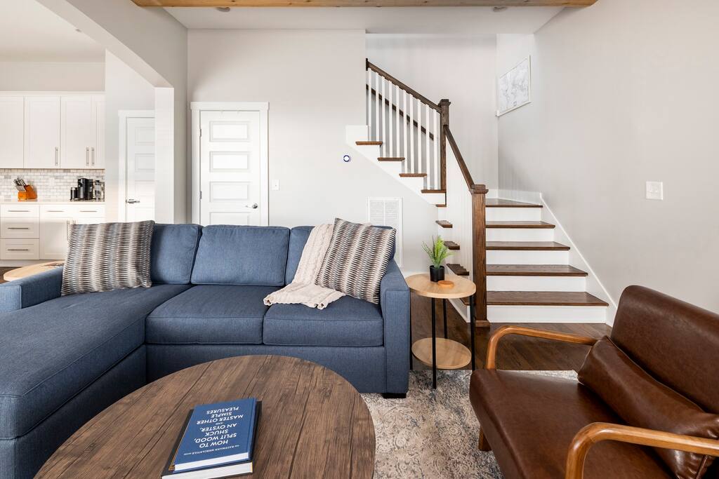 Living Room | Lounge Area | 1st Floor
Cozy lounge with a plush blue sectional, leather chairs, and rustic wood coffee table—perfect for game nights or relaxing before heading upstairs.