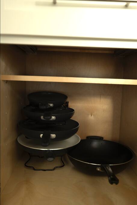 Kitchen | Cookware Cabinet | Fully Stocked
Lower cabinet neatly organized with a variety of nonstick frying pans and pots—ready for all your cooking needs during your stay.