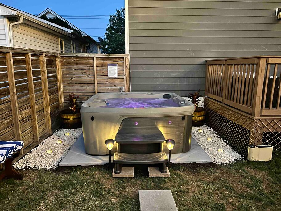 Backyard | Hot Tub Area | Private Retreat
Unwind in our private fenced backyard featuring a 7-person hot tub with LED lighting, towel hooks with striped robes, and a peaceful setting perfect for evening relaxation.