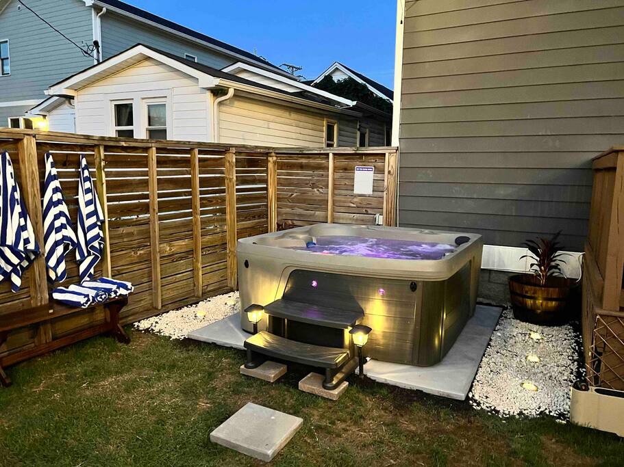 Backyard | Hot Tub Area | Private Retreat
Unwind in our private fenced backyard featuring a 7-person hot tub with LED lighting, towel hooks with striped robes, and a peaceful setting perfect for evening relaxation.