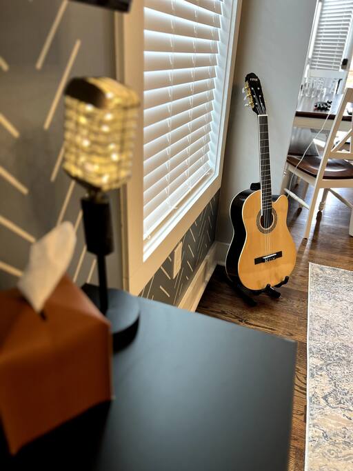 Country microphone lamp with acoustic guitar in the back.