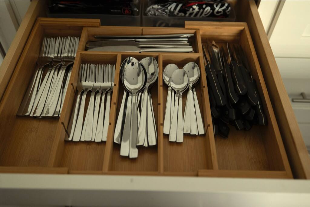 Kitchen | Silverware Drawer | Fully Stocked
Organized drawer with full sets of silverware—spoons, forks, knives, and serving utensils—neatly arranged in a wooden divider for easy access.