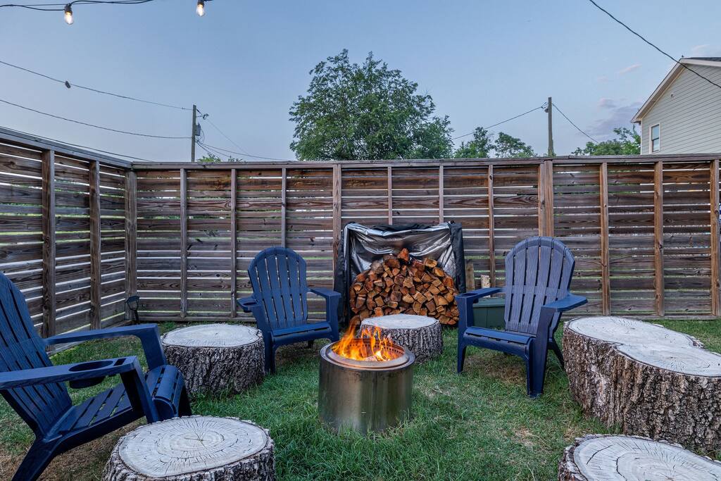 Backyard | Fire Pit Lounge | Evening Vibes
Private backyard lounge with a smokeless Solo Stove fire pit, Adirondack chairs, tree-stump seating, and stacked firewood—perfect for cozy nights under the stars.
