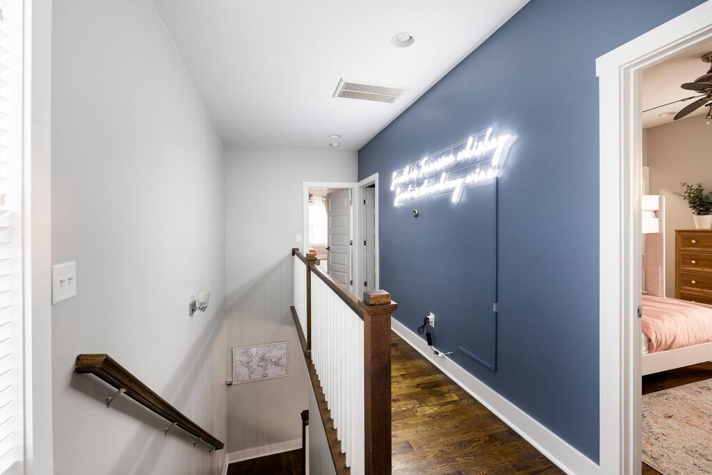 Bunk Bedroom on right, neon sign and master bedroom down the hall. Bottom left is our push pin map for guests to show where they have traveled from.