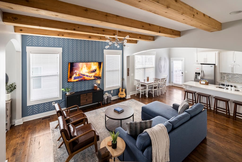 Living Room | Kitchen | Dining Room | 1st Floor
Sit back and relax in a spacious open living room with hand-painted accent wall, exposed wooden beams, a comfortable couch, and leather chairs to watch our 65" Vizio Smart TV included with 1 gig WiFi.