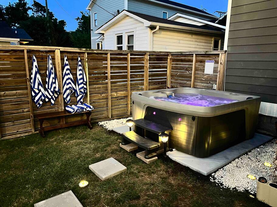 Backyard | Hot Tub Area | Private Outdoor Space
Relax in a private fenced backyard with a 7person hot tub featuring LED lights, striped towels, soft path lighting, and a bench perfect for unwinding under the stars after a fun day exploring Nashville.
