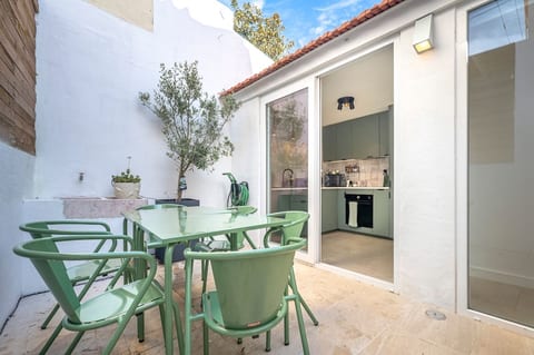 Outdoor Dining Oasis: Enjoy alfresco meals in a stylish scene, just steps from the kitchen!