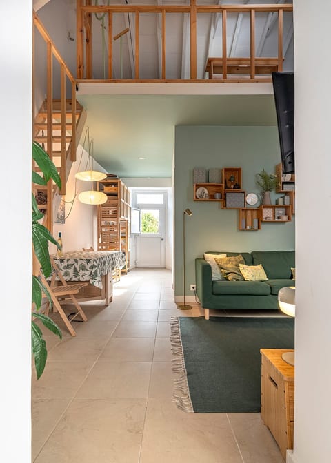 Living Room: Light-filled space featuring a stylish green sofa and inviting decor for relaxation!