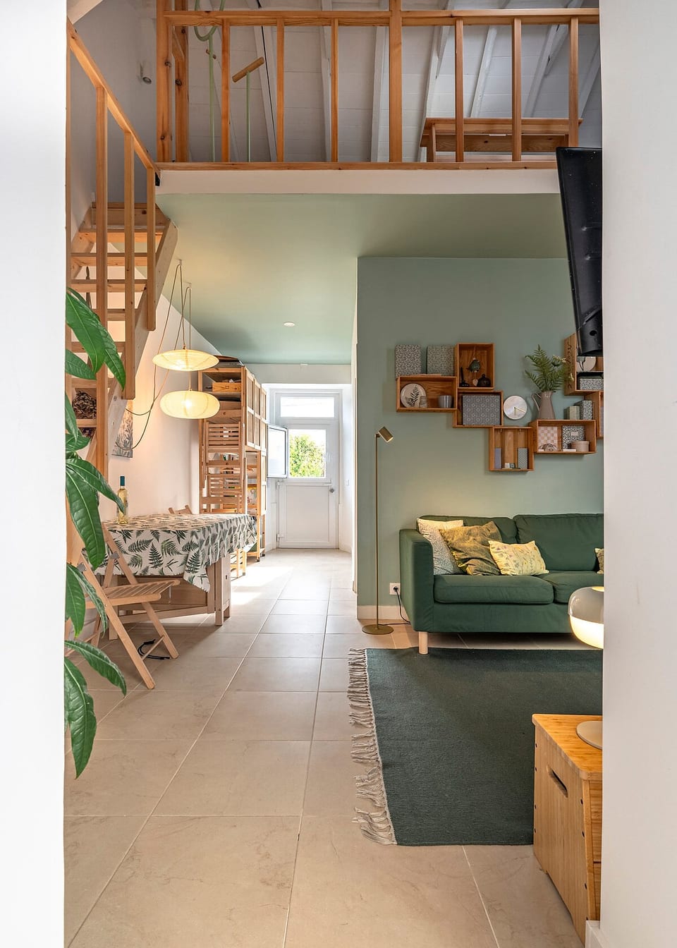 Living Room: Light-filled space featuring a stylish green sofa and inviting decor for relaxation!