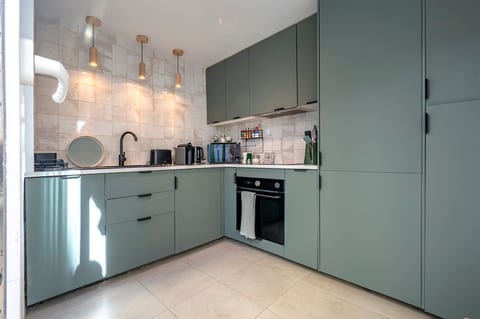Kitchen: Stylish design meets functionality with modern appliances and chic lighting!