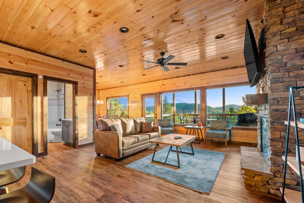 Living room on the main floor with electric fireplace and TV. Living room on the main floor with electric fireplace and TV. - Overlook Swim Lodge - Sevierville