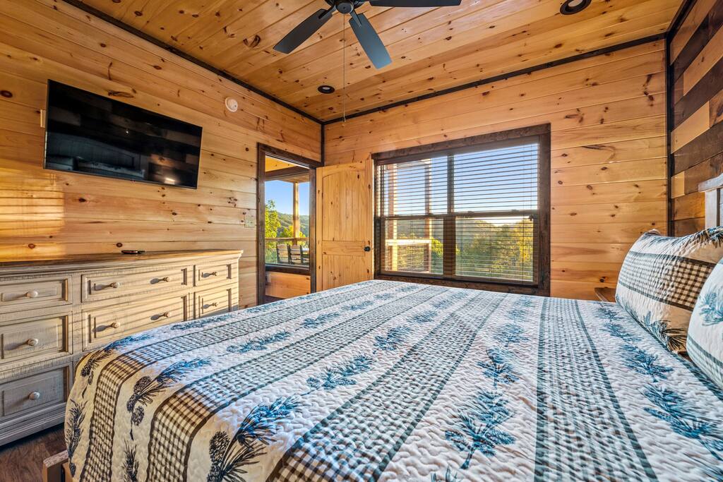 Main level bedroom with King bed. Main level bedroom with King bed. - Overlook Swim Lodge - Sevierville