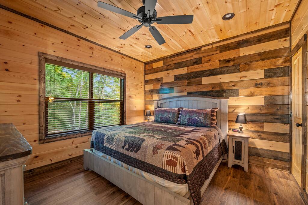 Main level bedroom with King bed. Main level bedroom with King bed. - Overlook Swim Lodge - Sevierville