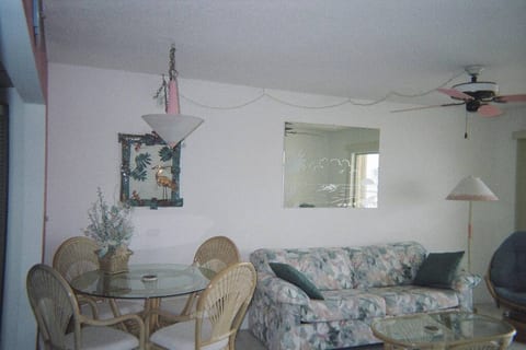 Living area with full ocean view and sliding doors that open to screeed in balcony