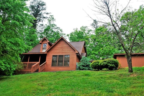 Bear Wood is nestled in the trees and has a lush front yard.