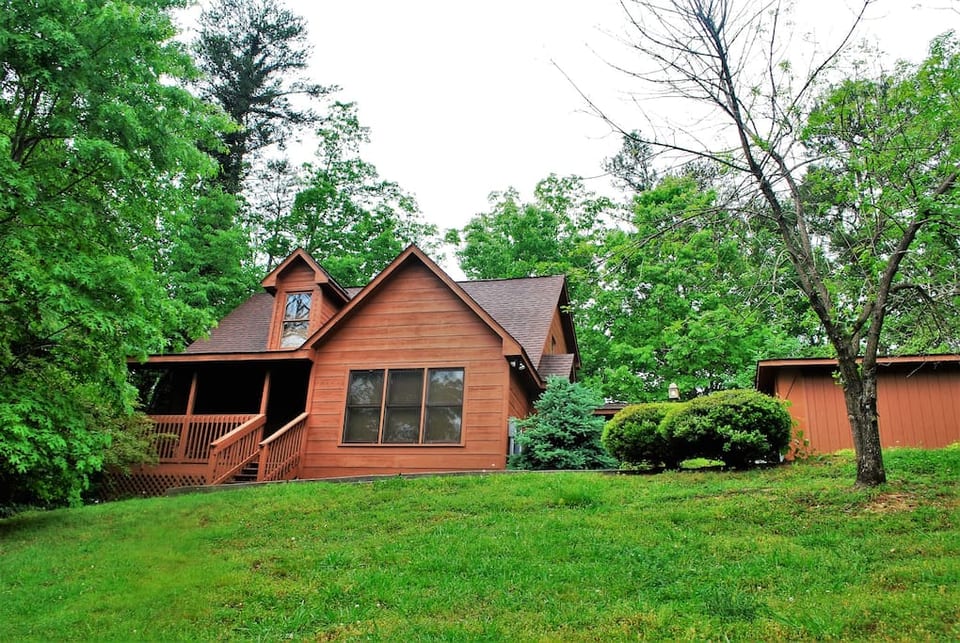 Bear Wood is nestled in the trees and has a lush front yard.