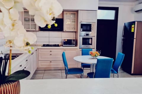 Very Spacious Kitchen with cooking utensils, plates and all the different types of glasses, it also has a mini dining area for 4 people, a cooker, microwave, toaster, kettle and all you need to prepare any food.