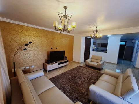 A very spacious Living room with a multi-channel television