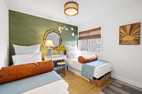 The twin beds are incredibly comfortable and feature baskets underneath for storing clothes. Bed rolls filled with extra pillows and blankets. Whether you need to do your makeup or take a work call, the first of two workstations is the perfect spot.