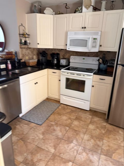 Fully stocked kitchen with all major appliances.