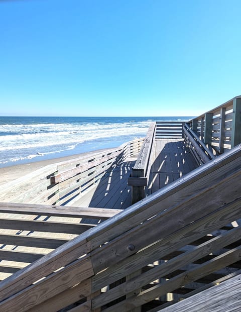 Handicap ramp adjoins a flat sidewalk along Corolla Village Rd. from our home