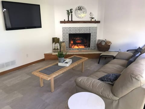 Warm comfortable living area with leather furniture, cable tv and roku.