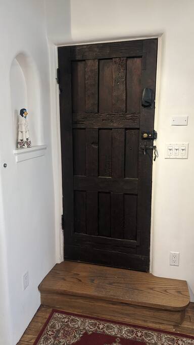 Beautiful old front door, full of character, with Acoma Pueblo pottery figurine in nicho. - Historic Casita Balentine, one block to Canyon Rd. - Santa Fe