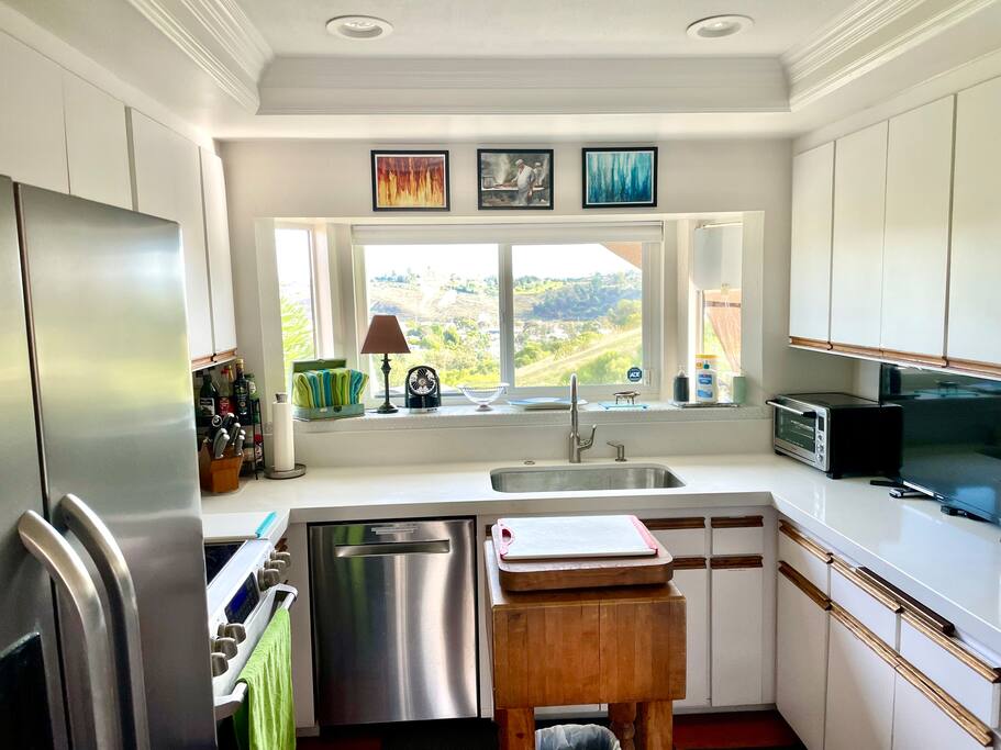 This kitchen is so much fun to work in because you have a gorgeous view out of the window. There is also a pet gate available next to the refrigerator for the door leading to the garage so you can make sure your pets stay inside. - Stunning View of Carlsbad; Private, 31 days min - Camp Pendleton North