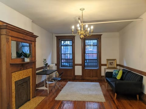 Large bedroom with queen size bed and fulton bed. Workstation. Windows are equipped with built-in shutters.