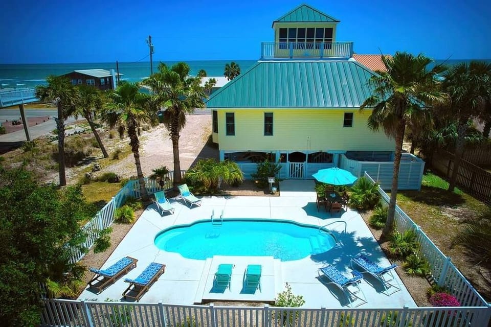 Beautiful private pool with lounge chairs and table seating for 6