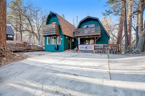 Large driveway with ample parking for 4 vehicles as you pull up to this unique double gambrel (two A-frames) style cabin