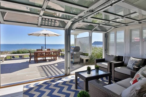 Garage style doors open up to turn the sun room in to an outdoor space. Indoor/Outdoor living at its best!