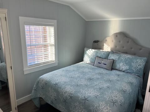 Bedroom with Queen bed, charging ports, dressers Smart TV and electric wall fireplace (not shown). We also changed out the fabric headboard to non-fabric.