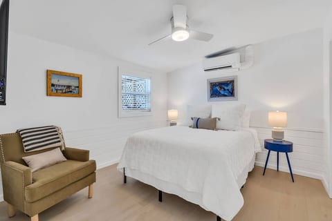 Main bedroom with queen bed with calm blue accents and comfortable bedding.