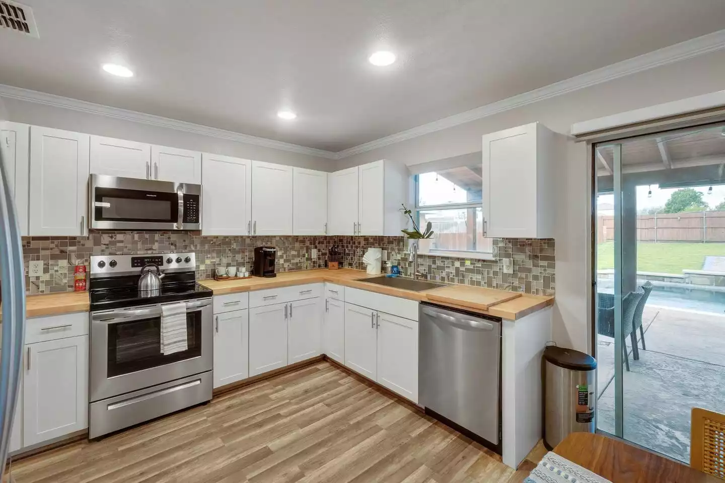 The backyard is right outside the door of the beautiful open, concept kitchen The backyard is right outside the door of the beautiful open, concept kitchen - The Coastal Breeze - Keller